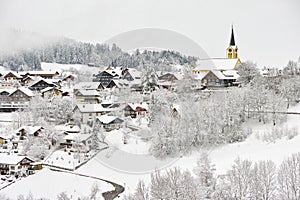 Snow-covered town with church magic winter season landscape