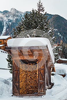 Snow covered traditional firewood hut