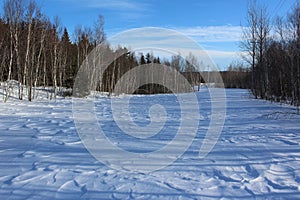 A snow-covered trail or back road in the countryside in rural Nova Scotia in wintertime