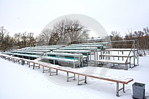 Snow covered tribune in a deserted park. Winter. Russia