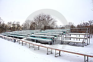 Snow covered tribune in a deserted park. Winter. Russia