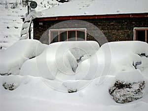 Snow covered vehicles in front of the hotel