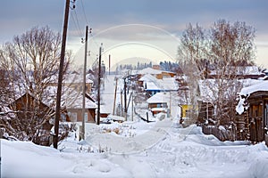 Snow-covered village street in Russian old-believer village Visim. Sverdlovsk region, Russia/