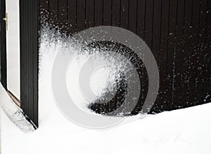 Snow-covered wall of the hut.