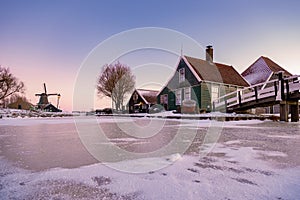 snow covered windmill village in the Zaanse Schans Netherlands, historical wooden windmills in winter Zaanse Schans