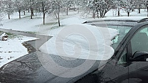 Snow covered windshield on car in rural winter landscape