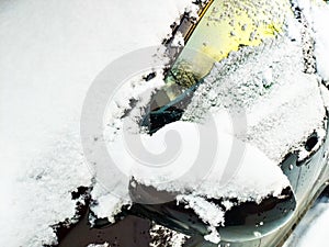 Snow-covered windshield, side window and left rear-view mirror