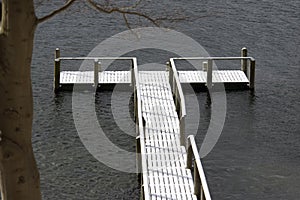 Snow-covered wooden bridge in the sea