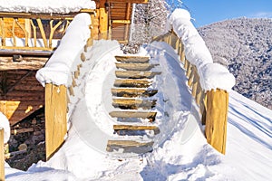 Snow covered wooden stairs in the mountains in winter