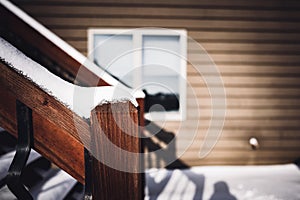 Snow covered wooden steps on a residential house