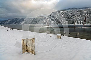 Snow covers this beach by Pend Oreille Lake.