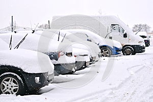 Snow cowered cars on a parking lot