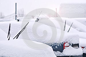 Snow cowered cars on a parking lot