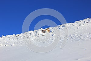 Snow-cowered rocks under deepblue sky