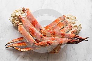 Snow Crab Legs on a light marble. Selective focus