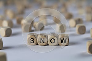 Snow - cube with letters, sign with wooden cubes