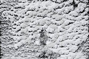 The Snow on a dark surface after a snowfall. The texture of the