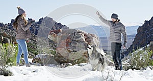 Snow, dog or couple playing in winter with freedom, adventure or fun on holiday vacation. Happy man, woman or people on