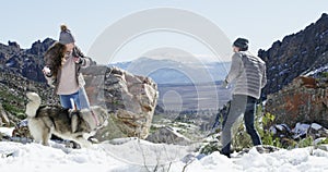 Snow, dogs or happy couple playing on winter vacation with freedom, adventure or fun games. Man, woman or people on