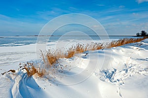 Snow dunes at a lake in Winter