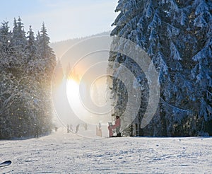 Snow dust dazzle shining on winter skiing slope photo