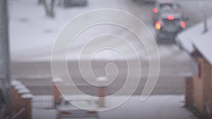 Snow falling in city on background of road