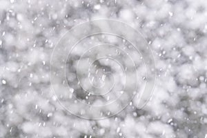 Snow falling and drifting in wind with soft defocused background