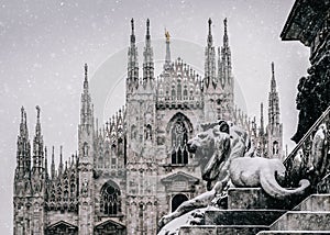 Snow falling at Piazza del Duomo in Milan, Lombardy, Italy with Milan`s landmark Cathedral in background