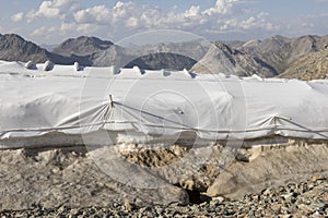 Snow farming on Diavolezza: Snow is covered with a flies against