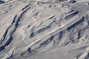 Snow fields covered with intricate patterns from the wind, a copy space, close-up.