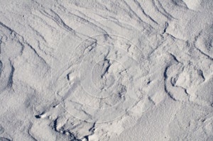 Snow fields covered with intricate patterns from the wind, a copy space, close-up.