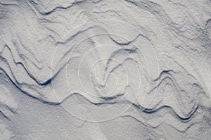 Snow fields covered with intricate patterns from the wind, a copy space, close-up.
