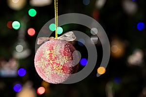 Snow flake Christmas ball ornament hanging on Christmas tree