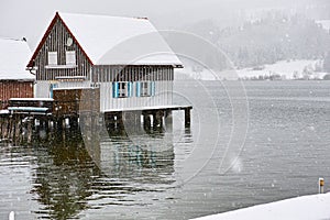 Stilt house at lake by snow flurry photo