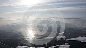 Snow is flying over surface of ice of Lake Baikal