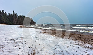 Snow on a frozen beach of the winter sea