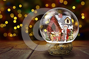 Snow Globe Against Christmas Lights Background