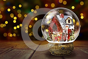 Snow Globe Against Christmas Lights Background