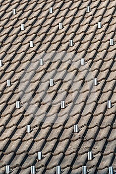 Snow guards or stoppers on house roof photo