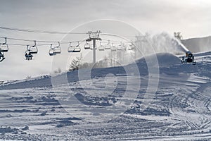 Snow gun and ski lifts on a sunny winter in Utah