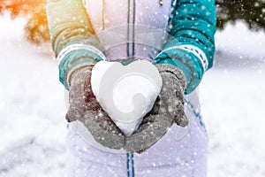 Snow heart in woman's heand. Winter romantic