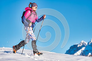 Snow hike with light crampons. A young woman