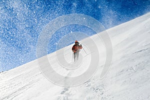 Snow hiker walking on snow during a snowstorm,s elective focus photo