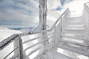 Snow and ice covered stairs, with strong sun backlight