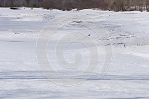 Snow, ice, hummocks on snow-covered ice of lake. A natural winter background .