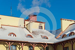 Snow and ice on the roofs of buildings. Icicles hang from the roofs of houses. The probability of the roof collapsing under the