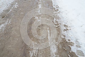 Snow, ice, slush and winter mud at a pedestrian crossing. The air temperature is about 0. Difficult driving conditions