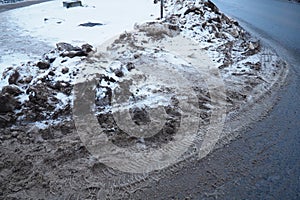 Snow, ice, slush and winter mud at a pedestrian crossing. The air temperature is about 0. Difficult driving conditions