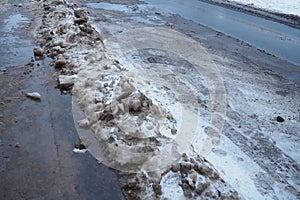 Snow, ice, slush and winter mud at a pedestrian crossing. The air temperature is about 0. Difficult driving conditions