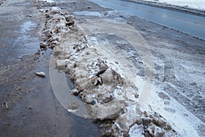 Snow, ice, slush and winter mud at a pedestrian crossing. The air temperature is about 0. Difficult driving conditions